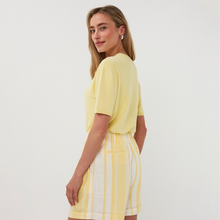 Load image into Gallery viewer, Woman wearing a yellow top and striped shorts on a white background
