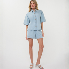 Load image into Gallery viewer, Woman wearing a light blue denim outfit on a white background
