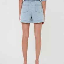 Load image into Gallery viewer, Light blue denim shorts worn by a person on a plain background
