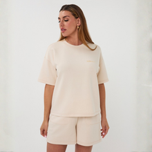 Load image into Gallery viewer, Woman wearing a beige outfit against a white background
