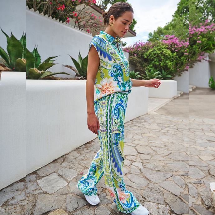 Side view of a model wearing Esqualo wide-leg trousers , in a ocean paisley print