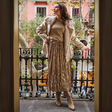 Load image into Gallery viewer, Woman standing on a street with a pink building in the background

