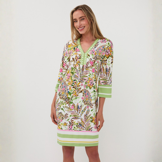 Woman wearing a colorful patterned dress on a white background