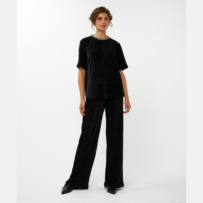 Person wearing a black outfit on a white background