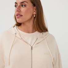 Load image into Gallery viewer, Woman in zip top 
