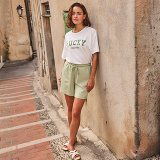 Lady in shorts and t-shirt on a street scene