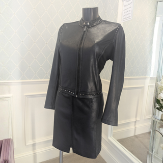 Full view of Eva kayan Leatherette Jacket on a mannequin, with a wallpapered green background.