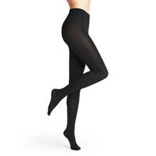 Load image into Gallery viewer, A model standing with one leg lifted while wearing the Falke Seidenglatt 80 Denier Tights in Black.
