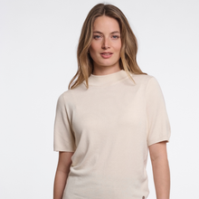 Load image into Gallery viewer, A woman with blonde hair wearing a short-sleeve knit top in a light cream color, photographed against a clean white studio background.
