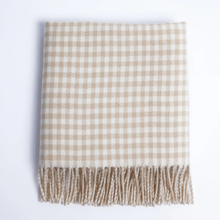Load image into Gallery viewer, A folded woven throw blanket with a beige and white gingham check pattern and fringed edges, shown on a plain white background.
