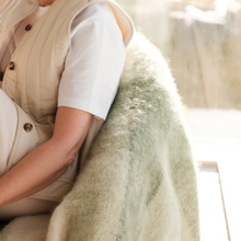 Load image into Gallery viewer, Throw over back of chair with woman sitting on it.
