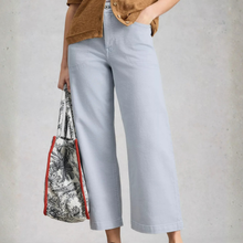 Load image into Gallery viewer, Low view of Model posing, wearing White Stuff Tia Wide Leg Crop Jean, with a  light grey background.
