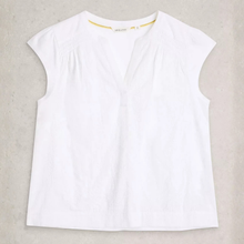 Load image into Gallery viewer, White sleeveless top on a beige background

