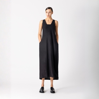 Woman wearing a black sleeveless dress on a white background