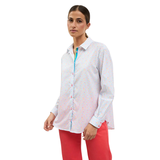 Woman wearing a white patterned shirt with a colorful zipper and red pants on a white background