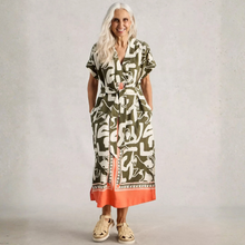 Load image into Gallery viewer, Woman wearing a patterned dress with a plain background
