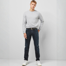 Load image into Gallery viewer, Model posing wearing Meyer M5 Regular Fit Jean, with a light grey background.
