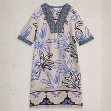 Load image into Gallery viewer, Beige dress with blue floral patterns on a light gray background
