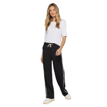Load image into Gallery viewer, Woman wearing a white top and black pants with a side stripe on a white background
