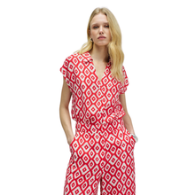 Load image into Gallery viewer, Woman wearing a red and white patterned jumpsuit on a white background
