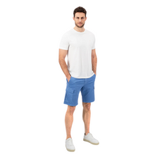 Load image into Gallery viewer, Front view of model with t-shirt and shorts, hands in pockets and trainers
