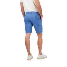 Load image into Gallery viewer, Lower half of model with rear view of the shorts hand in pockets and trainers 
