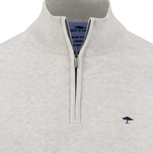 Load image into Gallery viewer, Close-up of a white quarter-zip pullover sweater with a ribbed mock neck collar and a small navy embroidered tree logo on the left chest.
