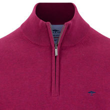 Load image into Gallery viewer, A close-up of a men's half-zip knit sweater in a rich magenta-pink color, featuring a ribbed mock neck collar, a silver metal zipper, and a small navy blue embroidered logo on the left chest.
