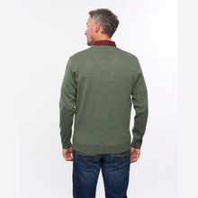 Load image into Gallery viewer, A man viewed from the back wearing an olive green knit sweater with a contrasting dark red collar, paired with blue jeans, against a plain white studio background.
