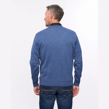 Load image into Gallery viewer, A man viewed from the back wearing a heathered blue long-sleeve knit sweater with a dark collar and blue jeans, set against a plain white studio background.
