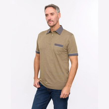 Load image into Gallery viewer, A man wearing a short-sleeve polo shirt in olive khaki with dark gray accents on the collar, sleeve cuffs, and chest pocket, paired with dark blue jeans, photographed against a plain white studio background.
