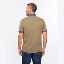 Load image into Gallery viewer, A man viewed from the back wearing a short-sleeve polo shirt in a heathered tan/khaki color with dark gray collar and sleeve trim, paired with blue jeans against a plain white studio background.

