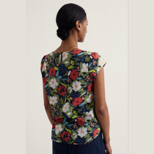 Load image into Gallery viewer, Woman wearing a floral sleeveless top on a plain background
