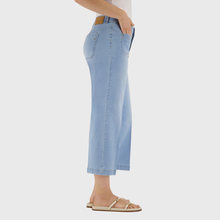 Load image into Gallery viewer, Light blue denim pants worn by a person on a white background
