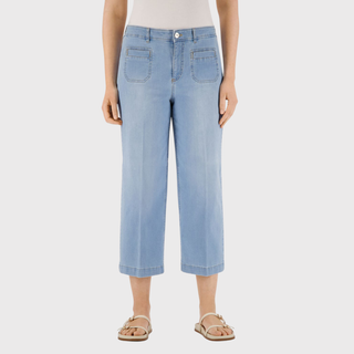 Light blue jeans worn by a person on a white background