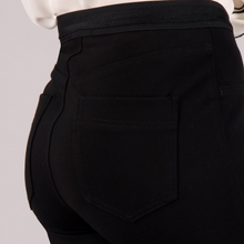 Load image into Gallery viewer, Close-up of black pants with a pocket on a light gray background

