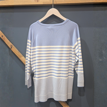 Load image into Gallery viewer, Back of Marella Ghiglia Striped Jumper in blue, with a wooden and blue background.
