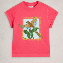 Load image into Gallery viewer, A coral pink short-sleeve t-shirt with a central graphic of a brown pheasant bird flying over green leaves, framed by a yellow patterned border, laid flat on a light gray textured background.
