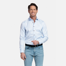 Load image into Gallery viewer, Man wearing a light blue dress shirt and jeans on a white background
