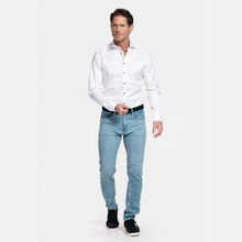 Load image into Gallery viewer, Man wearing a white dress shirt and light blue jeans on a white background
