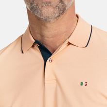 Load image into Gallery viewer, Close up of Polo Shirt on Male Model with button and logo detail 
