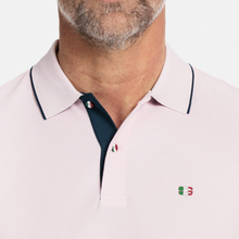 Load image into Gallery viewer, Close up of Polo Shirt on Male model with button details and logo 
