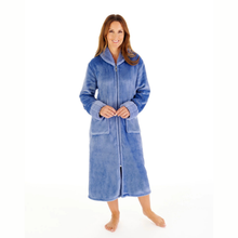 Load image into Gallery viewer, A woman wearing a plush, zip-front bathrobe in a medium blue color, standing against a solid white background.
