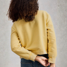 Load image into Gallery viewer, Person wearing a yellow textured sweater against a gray background
