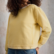 Load image into Gallery viewer, Person wearing a yellow textured sweater against a neutral background
