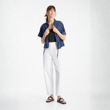 Load image into Gallery viewer, Woman wearing a blue shirt, black top, white pants, and sandals on a white background
