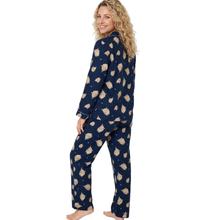 Load image into Gallery viewer, A woman modeling a navy blue pajama set with a beige and white dog print, shown from a side-back angle against a plain white background.
