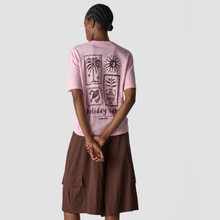 Load image into Gallery viewer, Person wearing a pink t-shirt with black graphics and text, standing against a plain background
