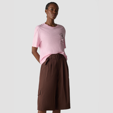 Load image into Gallery viewer, Person wearing a pink t-shirt and brown skirt on a light gray background
