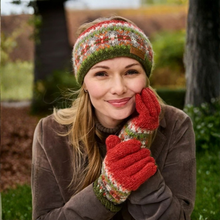 Load image into Gallery viewer, A woman outdoors wearing a knitted beanie and matching knit gloves with a red, green, and cream pattern, paired with a brown jacket.
